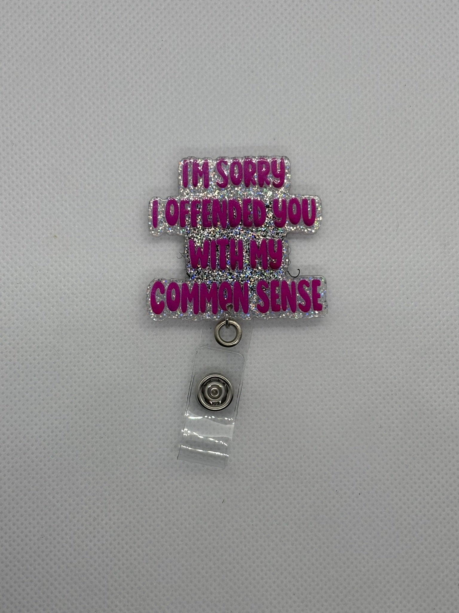 Pink “Common Sense” Badge Face